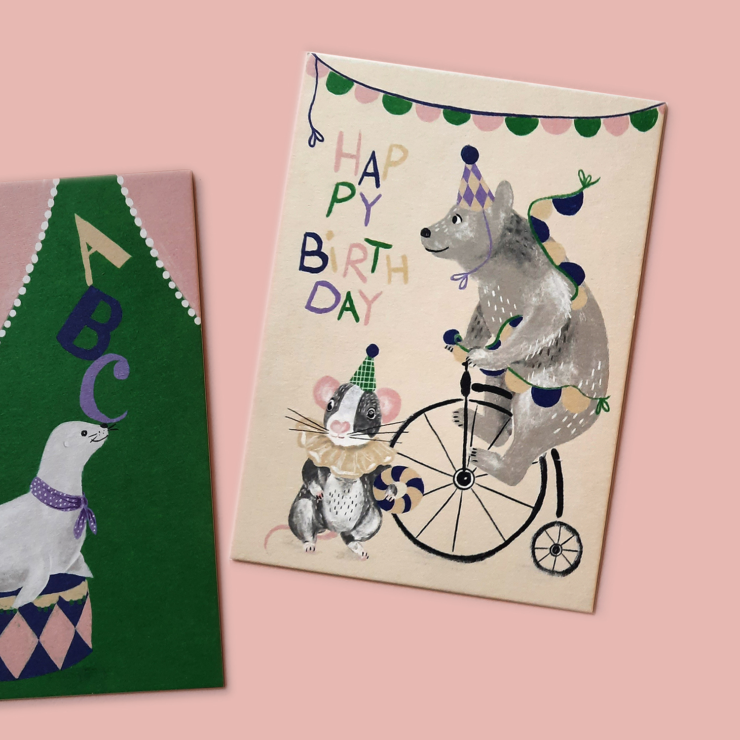 Charmante Postkarte mit einem Bären auf einem Zirkusrad und einer Maus. Gedruckt auf stabile Holzschliffpappe, ideal für besondere Geburtstagsgrüße.
